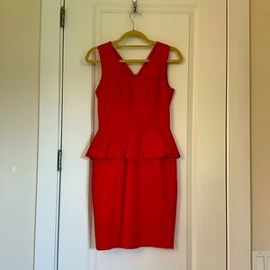 Beautiful red peplum mini dress with gold accent accent on the back!